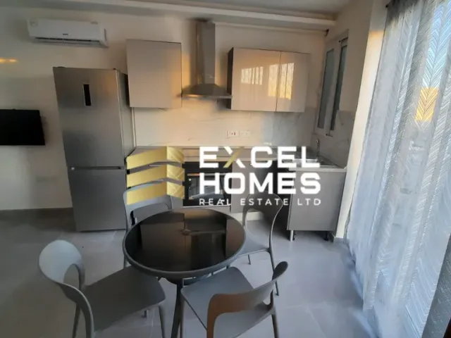 a living room with a table and chairs