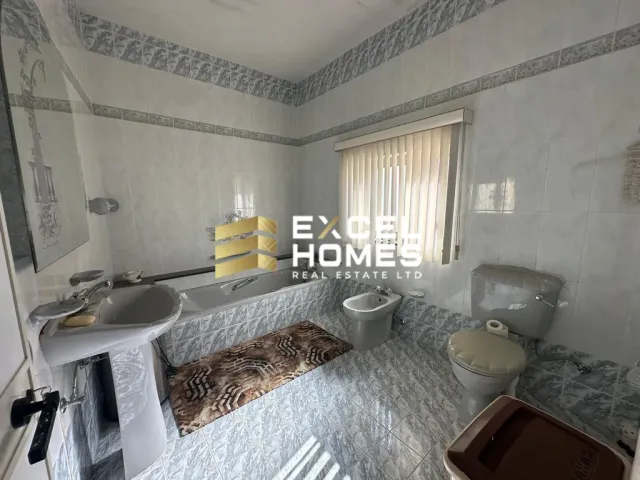 a bathroom with a toilet, sink, and bathtub