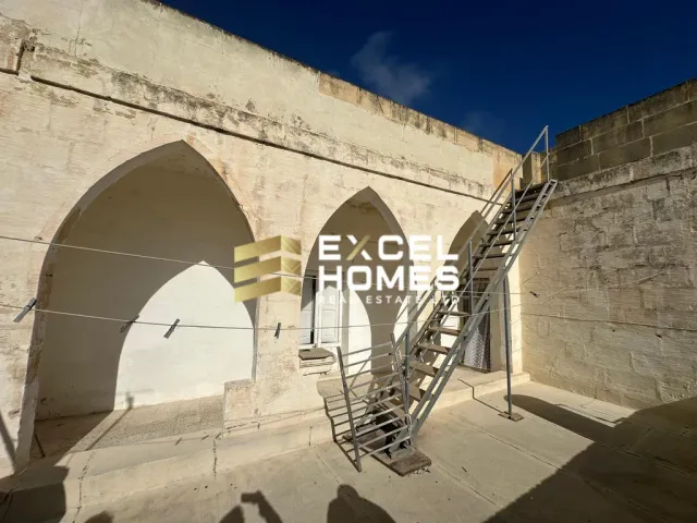 a building with a stairway leading to a stairway