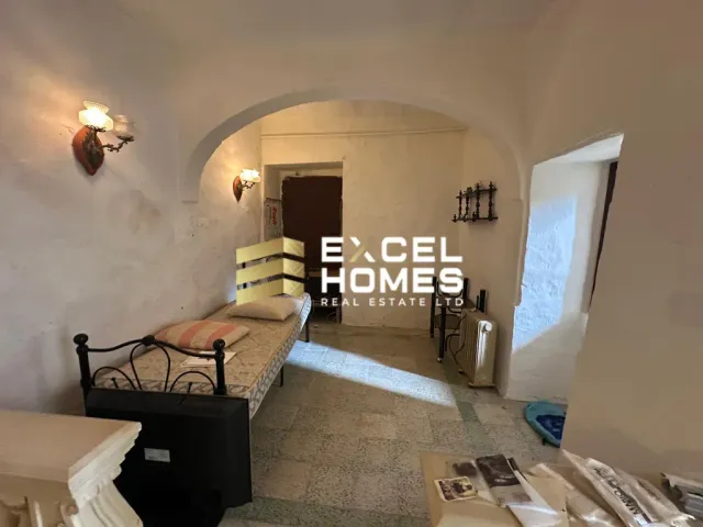 a room with a bed, a chair, and a wall