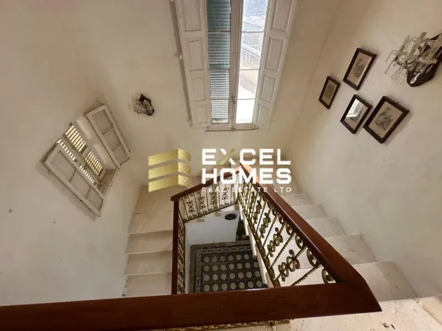 a large room with a large staircase leading to a stairwell