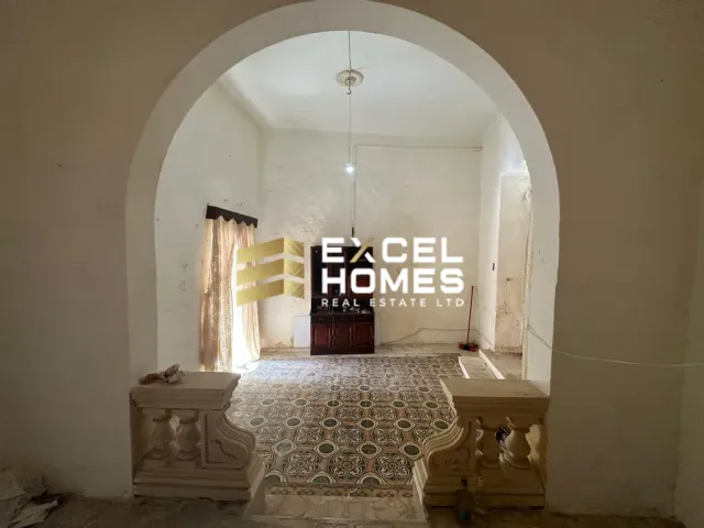 a bed with a white bedspread and a white wall