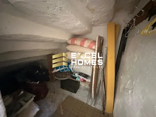 a room with a toilet and a wall with a wall