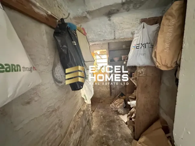 a room with a bunch of clothes hanging from the ceiling