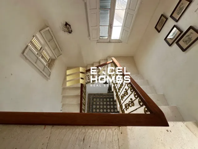 a room with a wall of stairs leading to a stairway