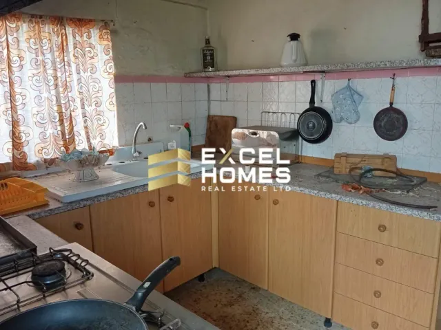 a kitchen with a sink, stove, and a window