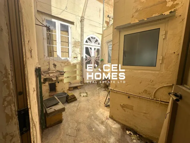 a room with a wall covered in a lot of clutter