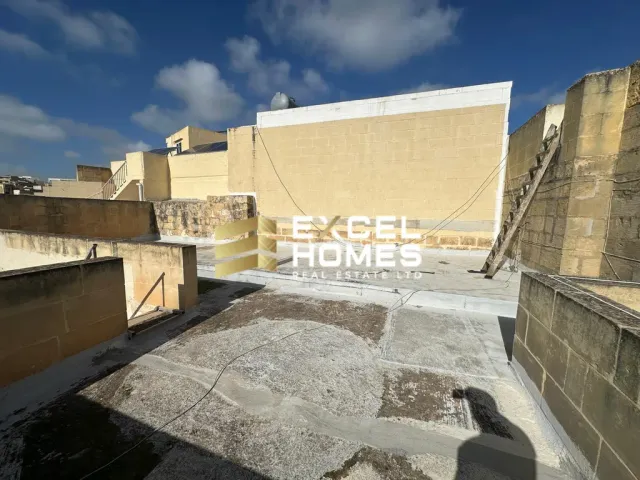 a building with a stone wall and a building with a stone wall