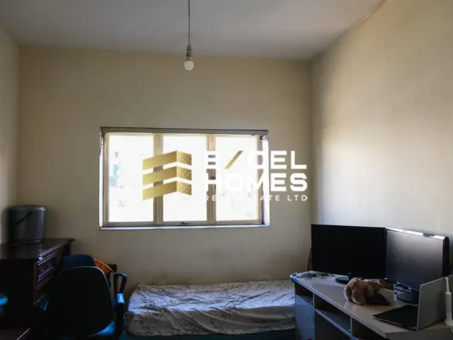 a bedroom with a bed and a tv 