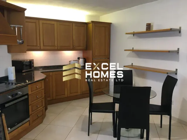 a kitchen with a table and chairs and a refrigerator