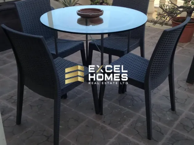 a table with a chair and a table cloth
