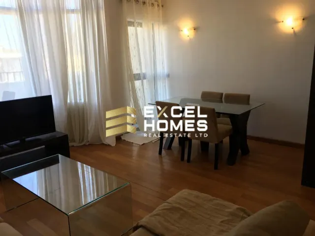 a living room with a table and chairs