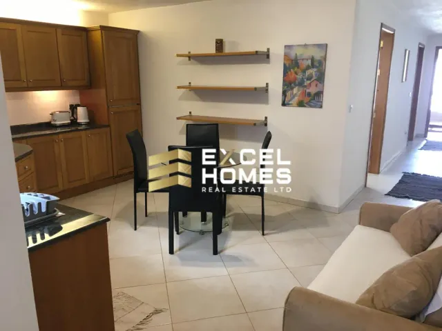 a living room with a table and chairs