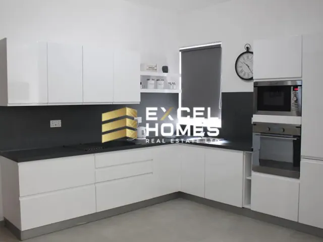 a kitchen with a microwave, refrigerator, and a counter top