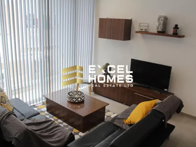 a living room with a couch, coffee table and a television