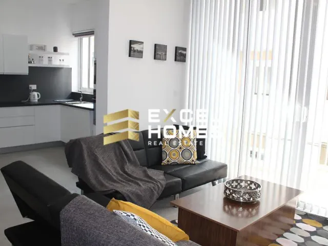 a living room with a couch, coffee table and a tv