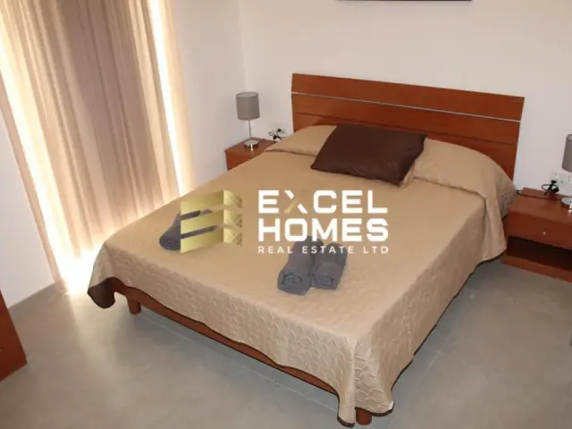 a bed with a white bedspread and a black and white bedspread