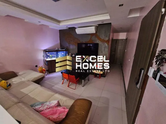a room with a bed, a television, and a couch 