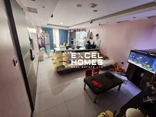 a living room with a couch, table, and a tv 
