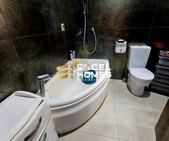 a bathroom with a toilet, sink, and bathtub 