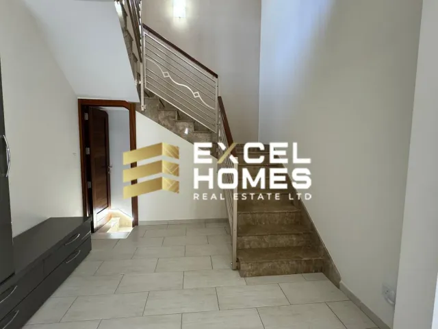 a small room with a staircase leading to a stairway