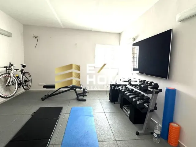 a living room with a television and a bicycle