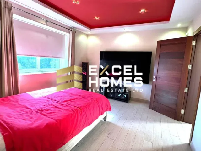 a bedroom with a bed, a dresser, and a window