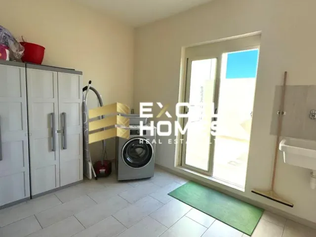 a bathroom with a sink, toilet and a window