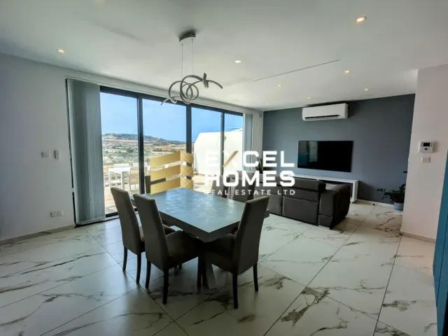 a dining room table with a television and chairs 