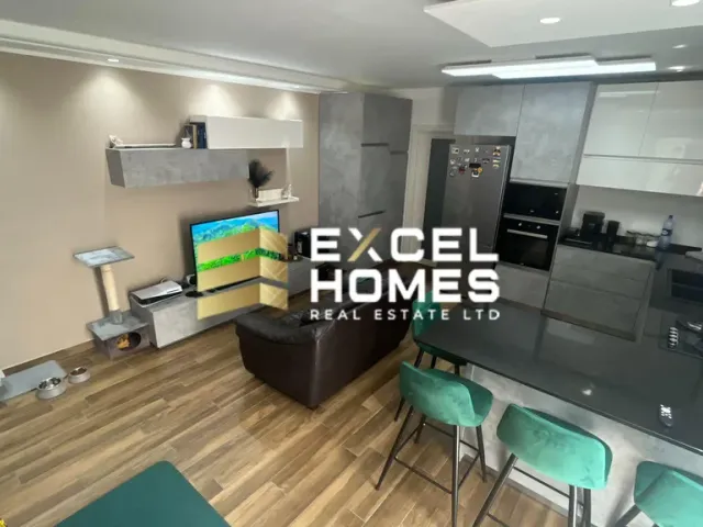 a kitchen with a television and a refrigerator