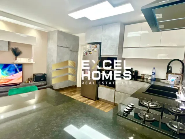 a kitchen with a large window and a large counter