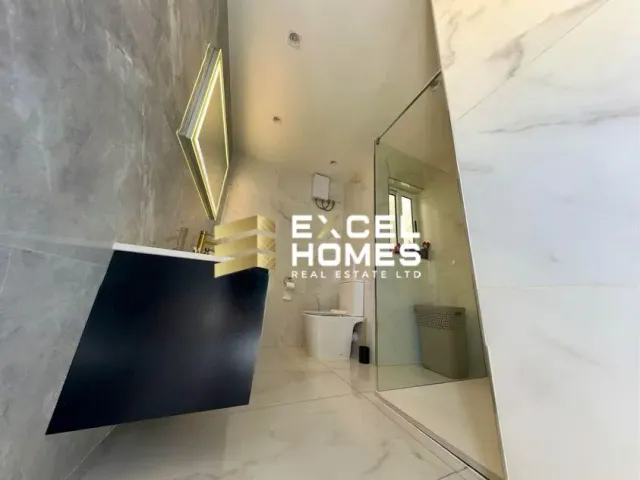 a bathroom with a toilet and a wall with a picture of a man on it