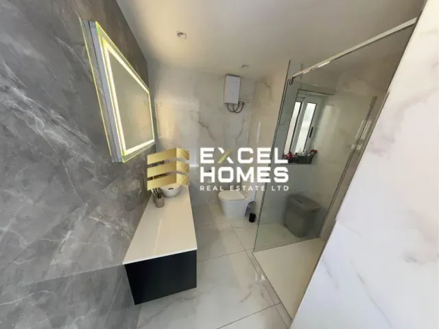 a bathroom with a toilet, sink, and mirror