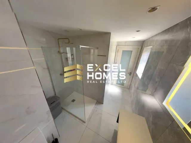 a bathroom with a shower, toilet and a mirror