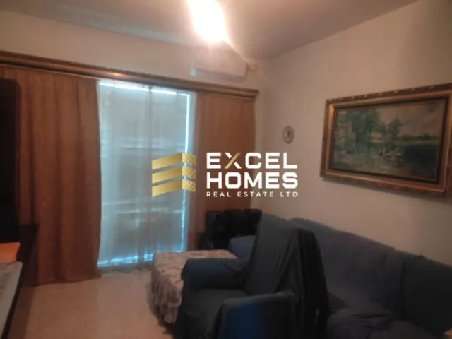 a living room with a couch, coffee table and a window