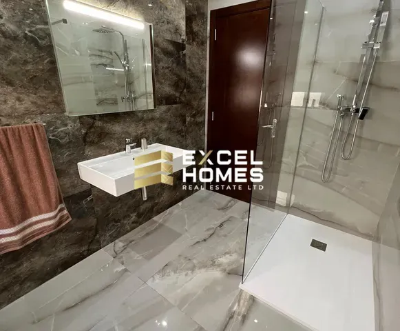 a bathroom with a shower, sink, and mirror