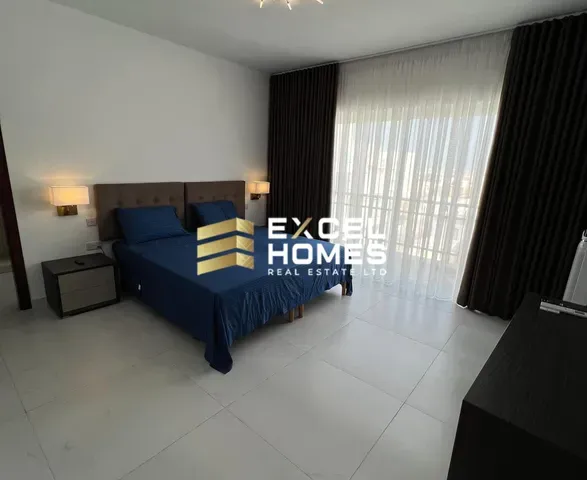 a bed room with a blue bedspread and a blue wall