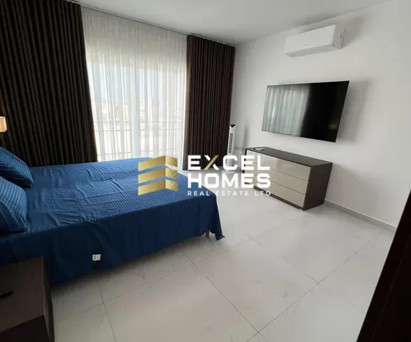 a bed room with a blue bedspread and a blue wall