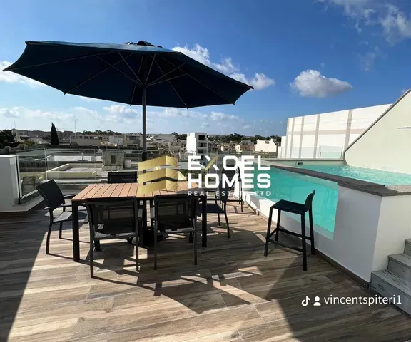 a patio table with a umbrella and chairs