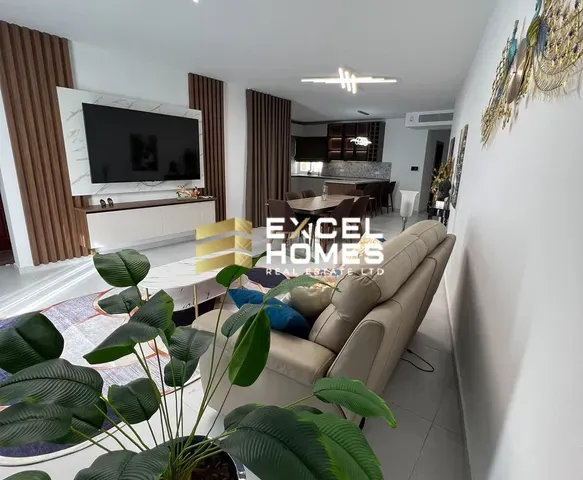 a living room with a couch, chair, and table