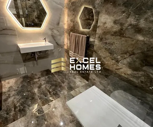 a bathroom with a wall of graffiti on it