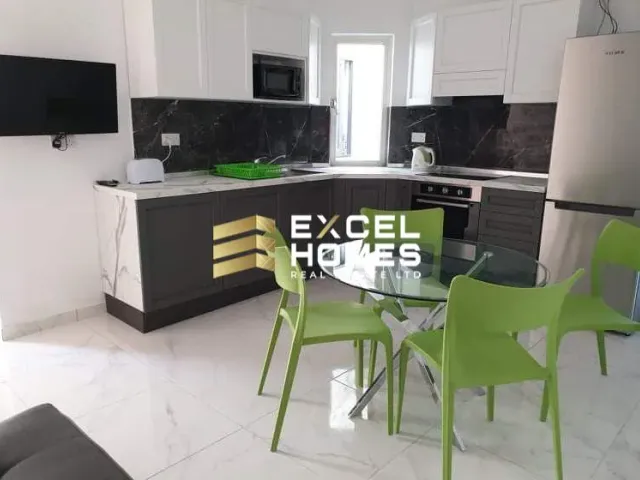 a kitchen with a table and chairs and a refrigerator