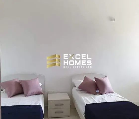 a bed with a white bedspread and pillows