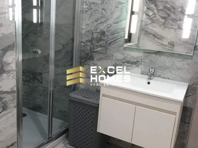 a bathroom with a shower, sink, and mirror