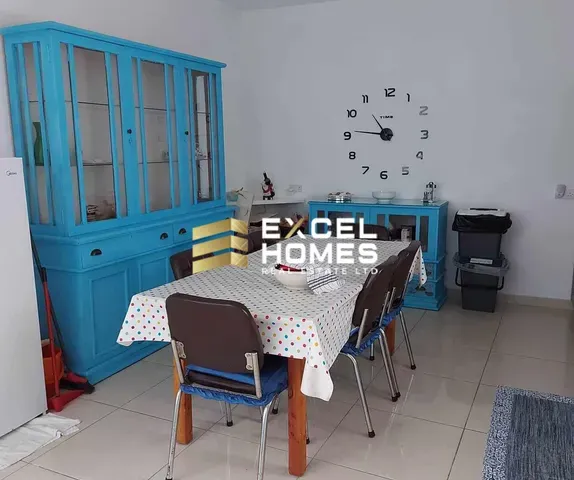 a room with a bed, table, and a window