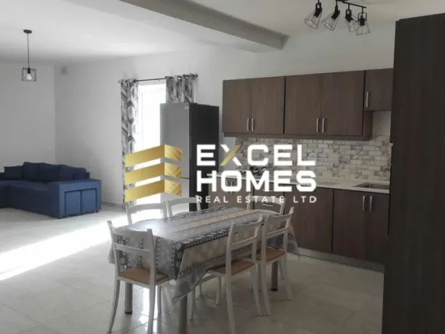 a kitchen with a table and a refrigerator