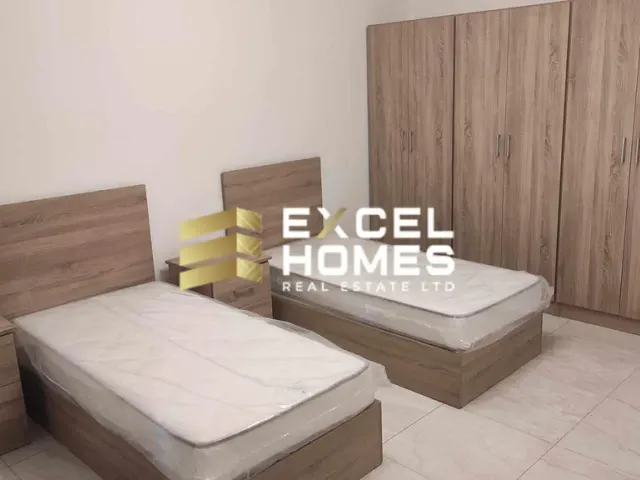 a bed with a white bedspread and a black and white bedspread