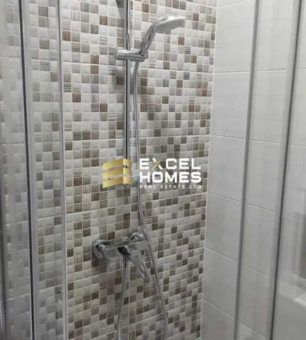 a bathroom with a large mirror and a large glass door
