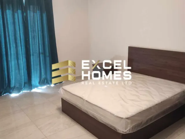 a bed with a white bedspread and a blue comforter