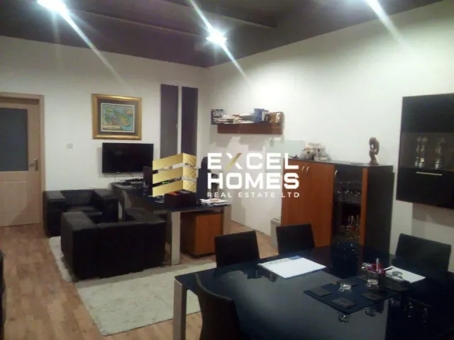 a living room with a couch, television, coffee table and a coffee table